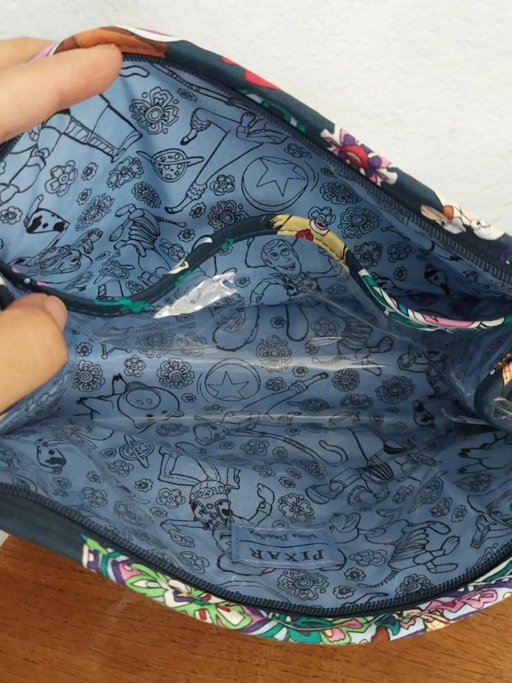 vera bradley Disney Pixar Toy Story quilted pouch with green dinosaur graphic an